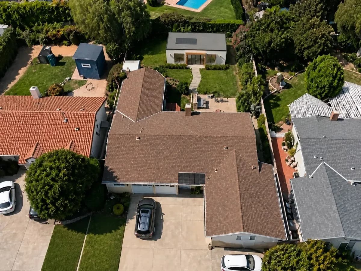 The same property with an early visual ADU concept placed in the rear yard. This is a rendered concept, not a photograph of a completed building.