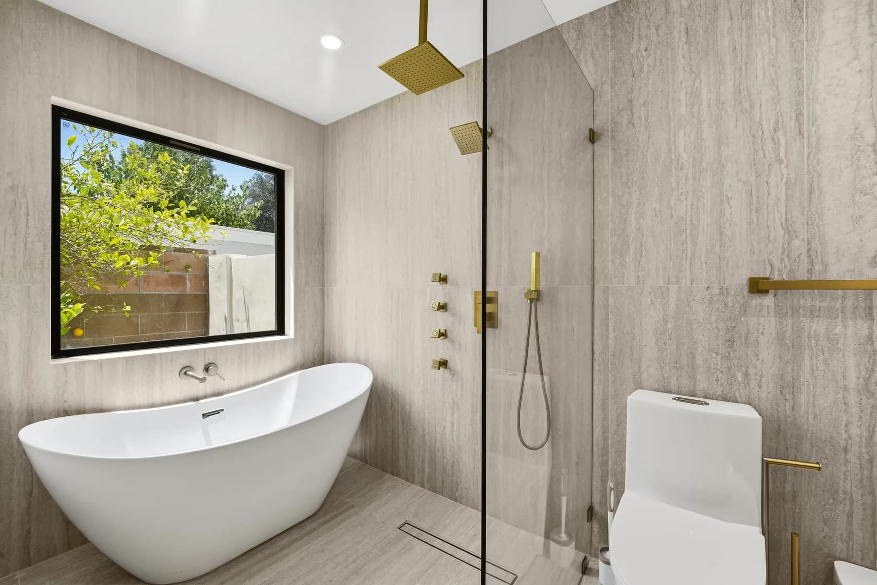 Bathroom at the Kentland project with a freestanding tub, a glass walk-in shower and a large window