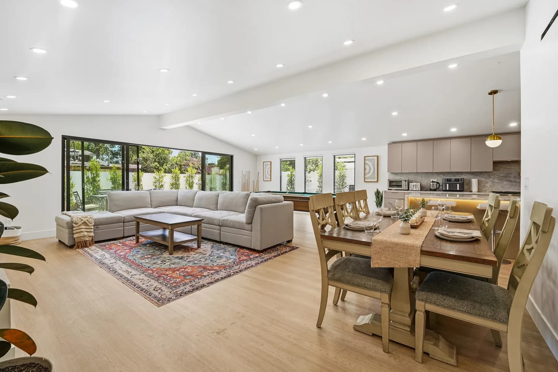Open-plan living and dining area at the Kentland project, with a vaulted ceiling and sliding doors to the garden