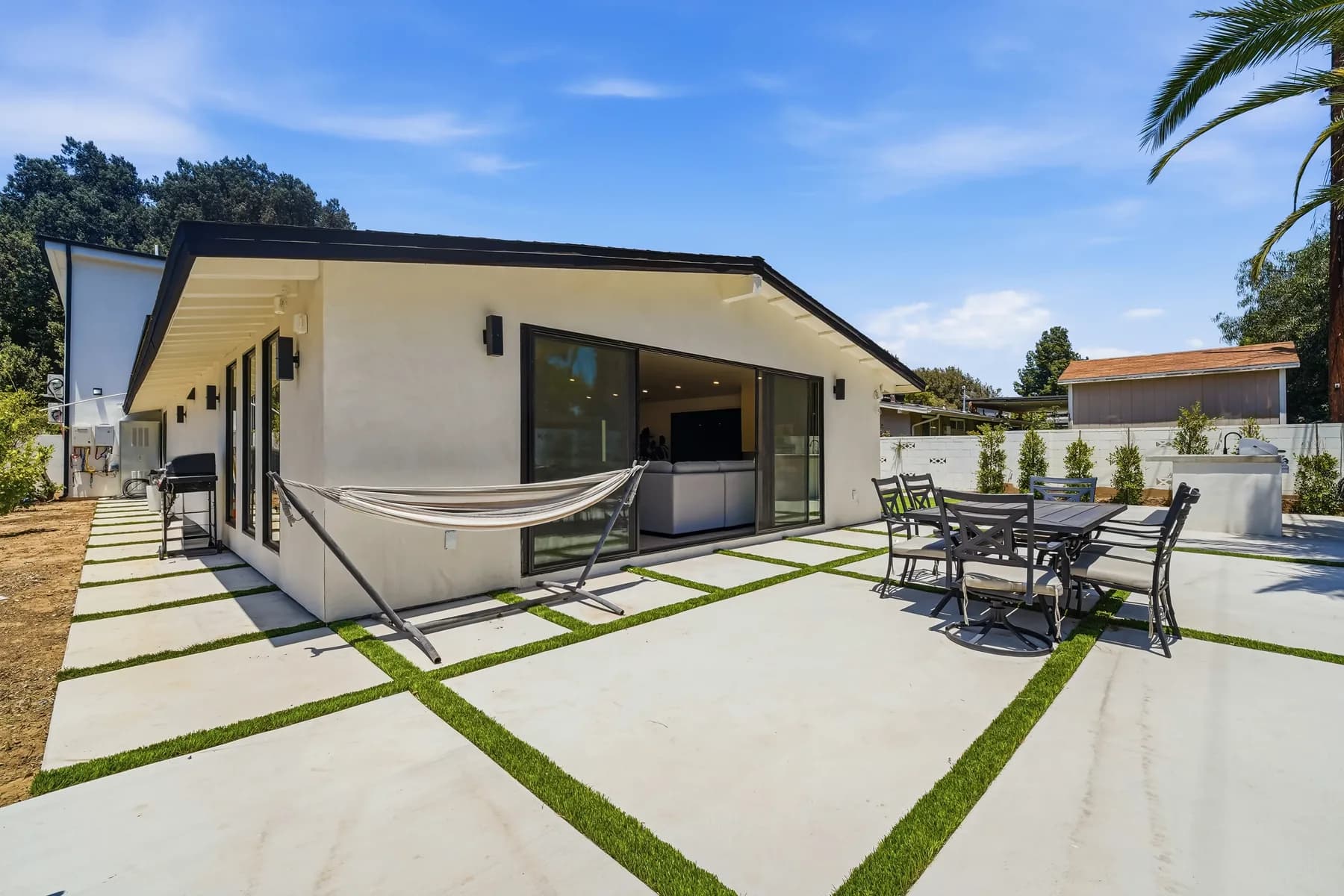 Rear patio at the Kentland project, with sliding doors, a hammock and banded hardscape