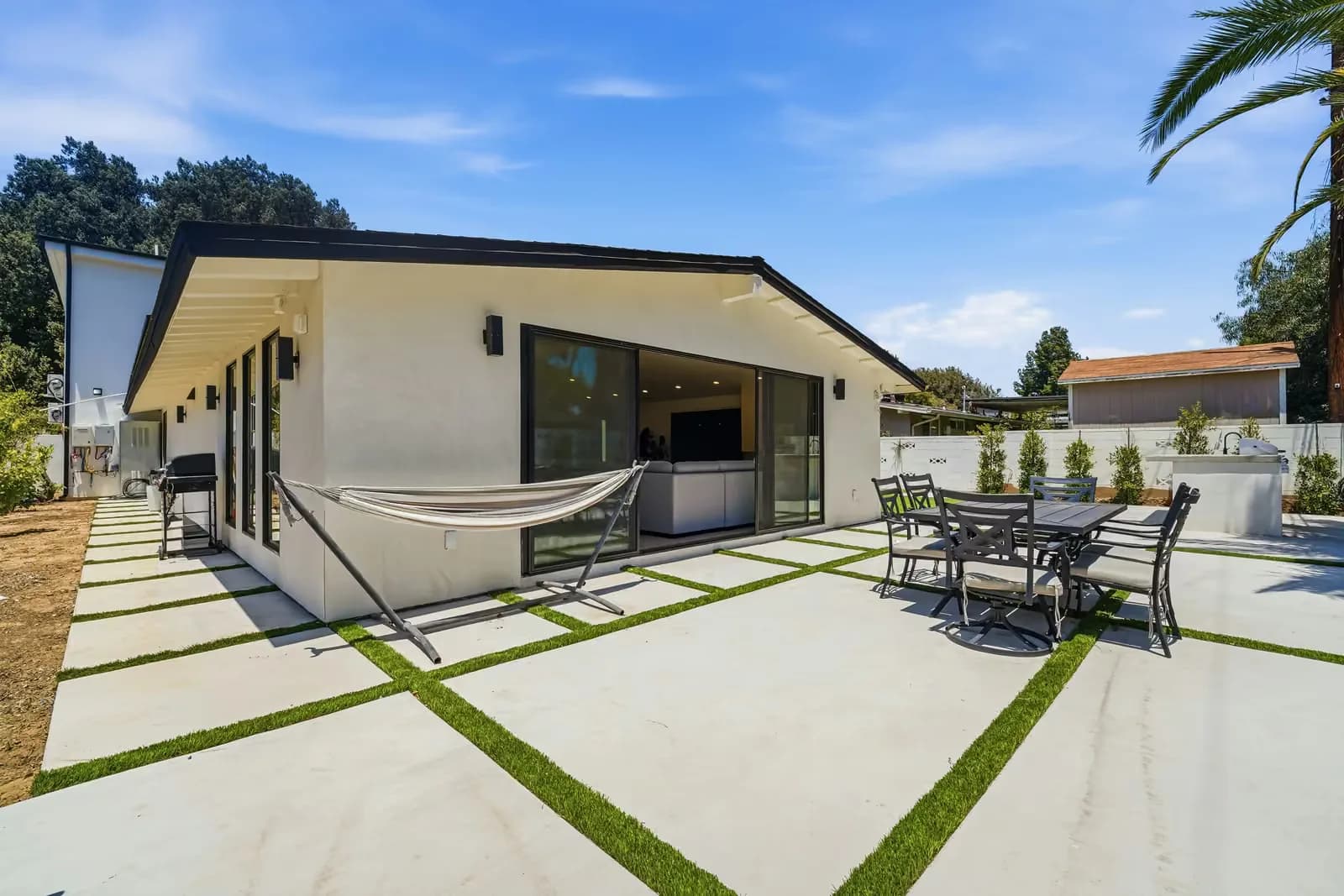 Rear elevation of a completed Yeganeh Inc. ADU, with a balcony and landscaped lawn